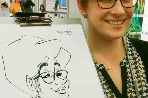 Schnellzeichner auf Messe, Karikatur auf Papier