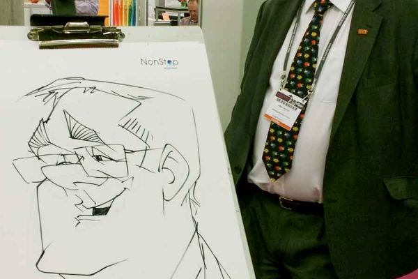 Schnellzeichner auf Messe, Karikatur auf Papier